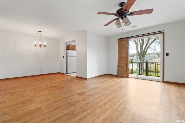 empty room with light wood-style floors, visible vents, baseboards, and ceiling fan with notable chandelier