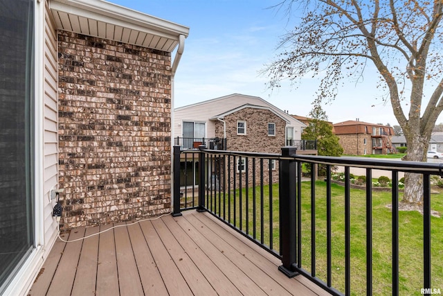wooden terrace featuring a yard