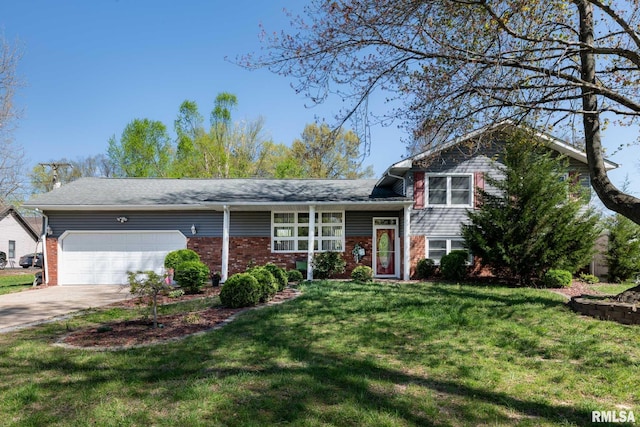 505 W College St, Energy, IL 62933 - split level home with an attached garage, a front lawn, brick siding, and concrete driveway
