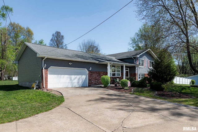505 W College St, Energy, IL 62933 - tri-level home featuring brick siding, an attached garage, a front lawn, and driveway