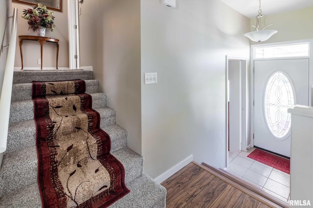505 W College St, Energy, IL 62933 - entryway featuring baseboards, wood finished floors, and stairway