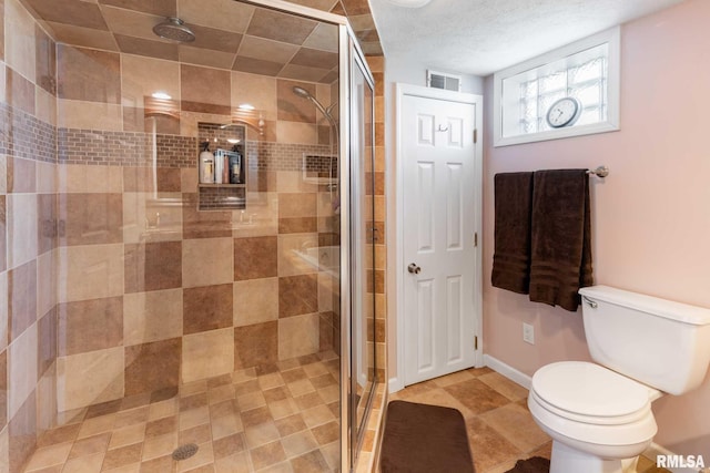 505 W College St, Energy, IL 62933 - full bath featuring a shower stall, toilet, visible vents, and baseboards