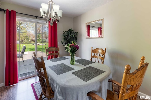 505 W College St, Energy, IL 62933 - dining room with wood finished floors, a wealth of natural light, and an inviting chandelier