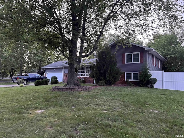 505 W College St, Energy, IL 62933 - view of front of house featuring a garage, a front lawn, and fence