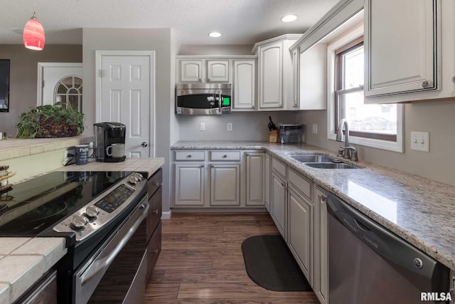 505 W College St, Energy, IL 62933 - kitchen with white cabinetry, a sink, decorative light fixtures, appliances with stainless steel finishes, and dark wood-style flooring