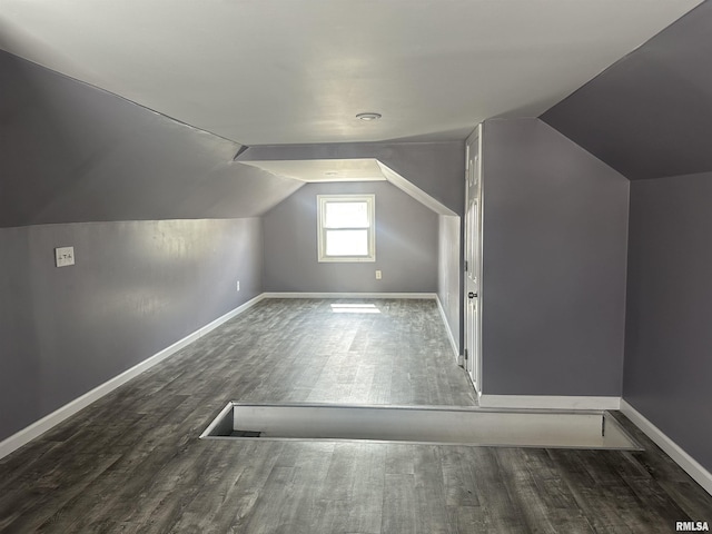 additional living space with vaulted ceiling, baseboards, and wood finished floors
