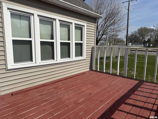 wooden terrace with a lawn