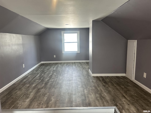 bonus room featuring baseboards, lofted ceiling, and dark wood-style floors