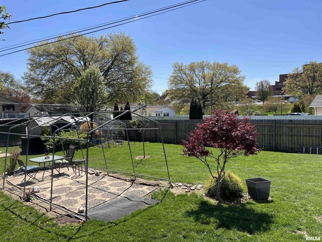 rear view of house featuring fence, a deck, a chimney, cooling unit, and a yard