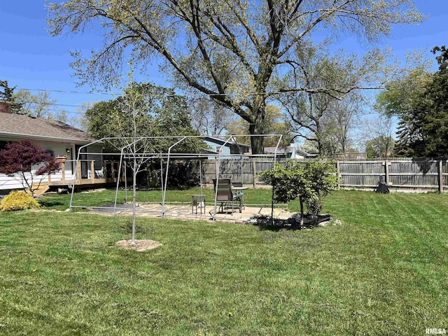 view of yard featuring a patio area and a wooden deck