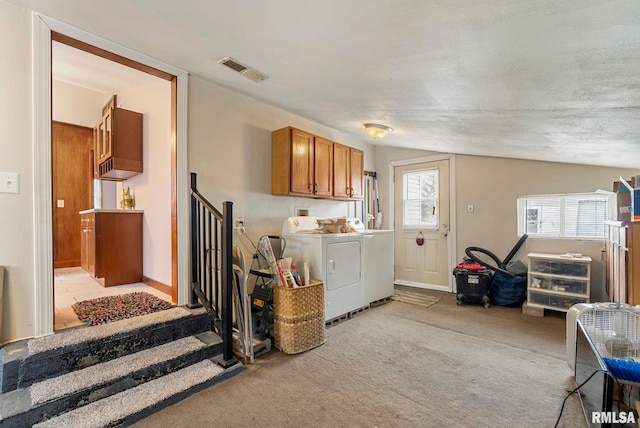 washroom featuring baseboards, visible vents, light colored carpet, independent washer and dryer, and cabinet space