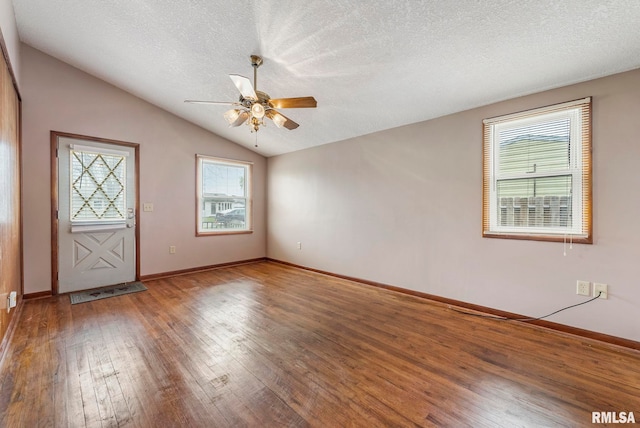 foyer entrance with hardwood / wood-style floors, lofted ceiling, a wealth of natural light, a textured ceiling, and ceiling fan