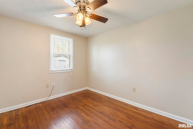 spare room featuring ceiling fan, baseboards, hardwood / wood-style floors, and a textured ceiling