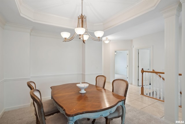 1357 Pinnacle Pines Ct, Bettendorf, IA 52722 - dining room featuring ornamental molding, a chandelier, ornate columns, a raised ceiling, and light tile patterned floors