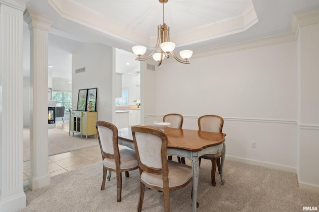 1357 Pinnacle Pines Ct, Bettendorf, IA 52722 - dining space featuring light colored carpet, crown molding, a chandelier, a tray ceiling, and a multi sided fireplace