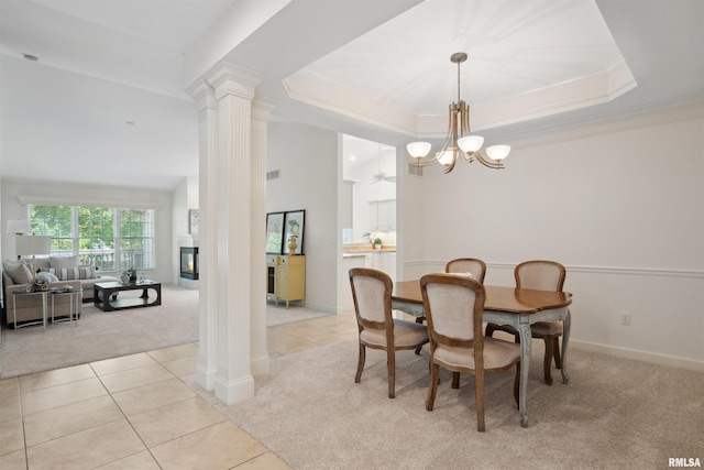 1357 Pinnacle Pines Ct, Bettendorf, IA 52722 - dining area featuring light colored carpet, crown molding, a chandelier, ornate columns, and light tile patterned flooring