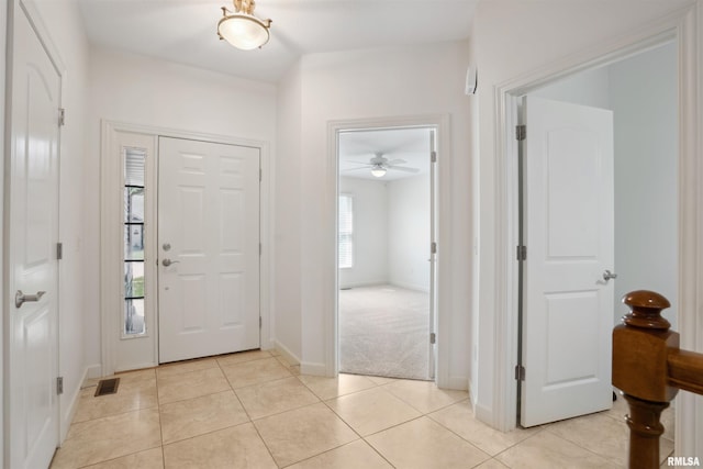 1357 Pinnacle Pines Ct, Bettendorf, IA 52722 - entrance foyer featuring baseboards, light tile patterned floors, and ceiling fan