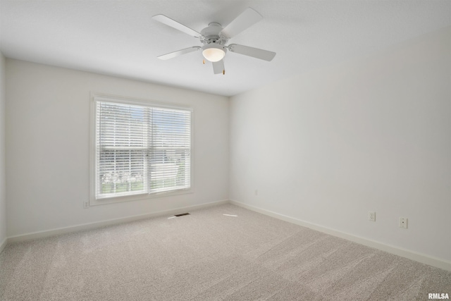 1357 Pinnacle Pines Ct, Bettendorf, IA 52722 - unfurnished room with baseboards, carpet, and ceiling fan
