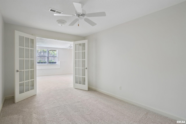 1357 Pinnacle Pines Ct, Bettendorf, IA 52722 - empty room with french doors, carpet flooring, baseboards, and ceiling fan