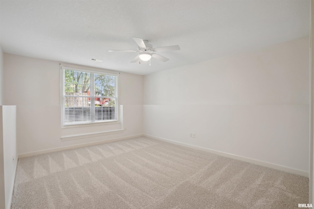 1357 Pinnacle Pines Ct, Bettendorf, IA 52722 - carpeted empty room with baseboards and a ceiling fan