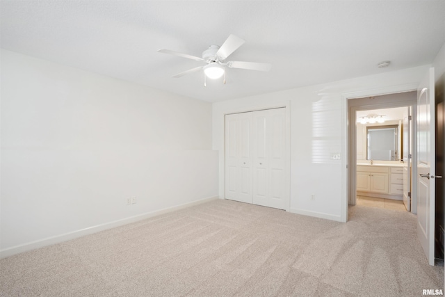 1357 Pinnacle Pines Ct, Bettendorf, IA 52722 - unfurnished bedroom with light colored carpet, a closet, baseboards, and a ceiling fan