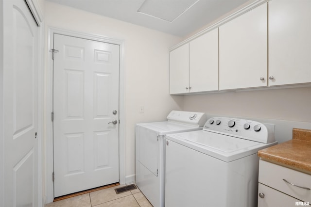 1357 Pinnacle Pines Ct, Bettendorf, IA 52722 - laundry area featuring cabinet space, washer and clothes dryer, and light tile patterned flooring