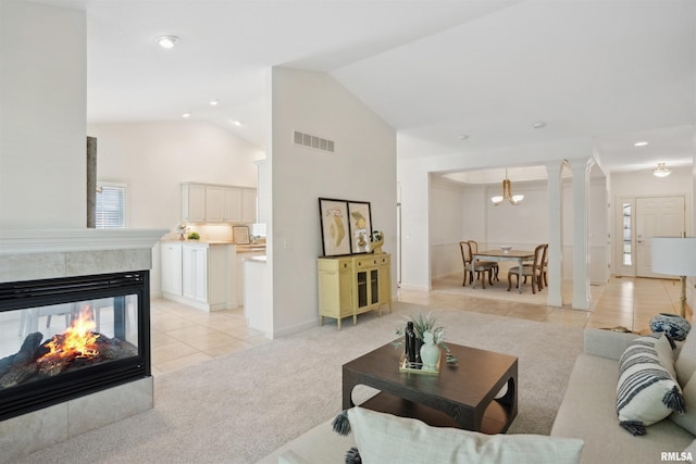 1357 Pinnacle Pines Ct, Bettendorf, IA 52722 - living area featuring light tile patterned floors, a chandelier, recessed lighting, high vaulted ceiling, and baseboards