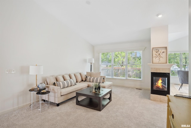 1357 Pinnacle Pines Ct, Bettendorf, IA 52722 - living room featuring carpet flooring, a tile fireplace, baseboards, and vaulted ceiling