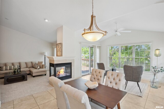1357 Pinnacle Pines Ct, Bettendorf, IA 52722 - dining space featuring light tile patterned floors, lofted ceiling, a fireplace, ceiling fan, and light carpet