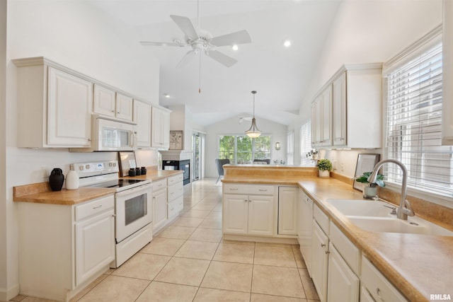 1357 Pinnacle Pines Ct, Bettendorf, IA 52722 - kitchen featuring white appliances, lofted ceiling, a sink, ceiling fan, and a peninsula