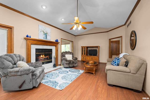 living area featuring crown molding, a ceiling fan, visible vents, and hardwood / wood-style flooring