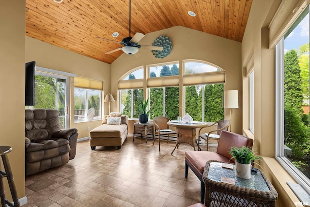 sunroom featuring wooden ceiling, baseboards, and stone tile flooring