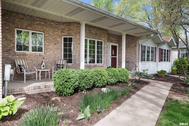 doorway to property featuring brick siding
