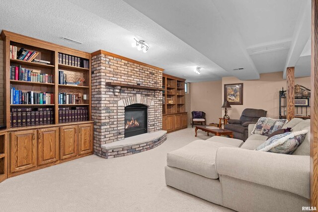 living room with a brick fireplace, a textured ceiling, visible vents, and carpet