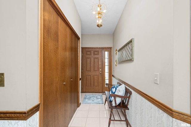 entryway featuring light tile patterned floors and a chandelier
