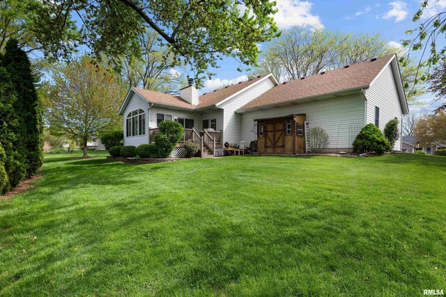 ranch-style house featuring a shingled roof, an attached garage, driveway, and a front yard