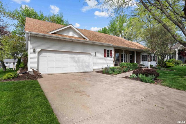 ranch-style home featuring a garage, driveway, and a front yard