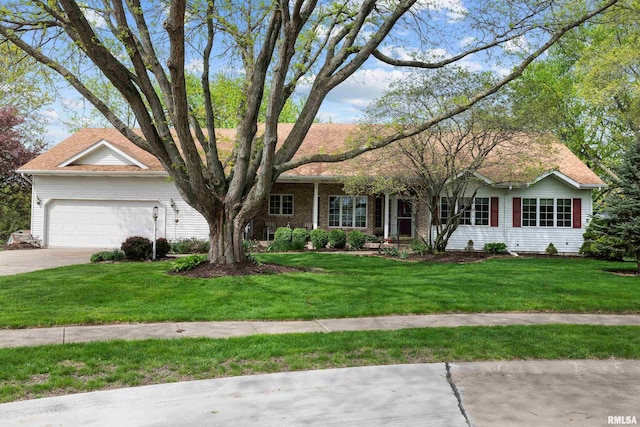 ranch-style house featuring an attached garage, driveway, and a front lawn