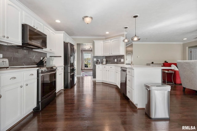 409 Arbor Dr, Carterville, IL 62918 - kitchen featuring ornamental molding, dark wood-type flooring, a peninsula, appliances with stainless steel finishes, and open floor plan
