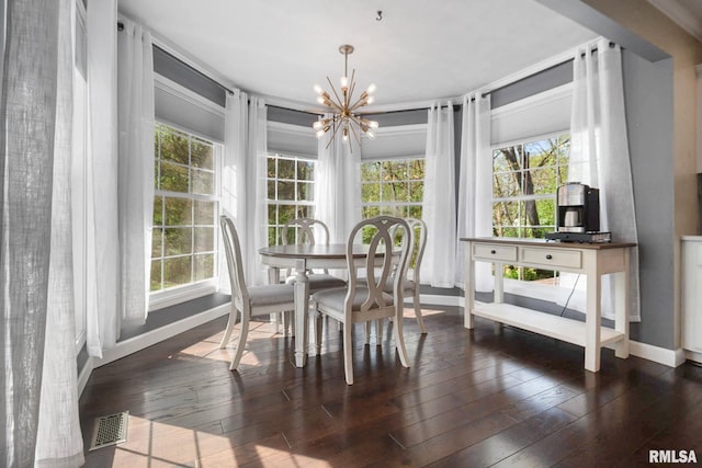 409 Arbor Dr, Carterville, IL 62918 - dining area with baseboards, a chandelier, visible vents, and plenty of natural light