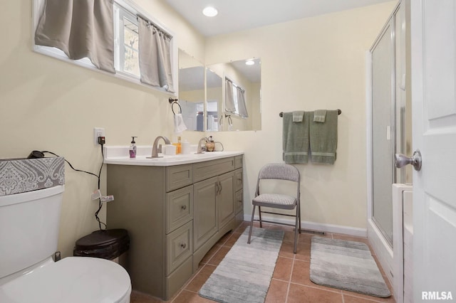 409 Arbor Dr, Carterville, IL 62918 - bathroom featuring a sink, double vanity, toilet, a shower with door, and tile patterned flooring