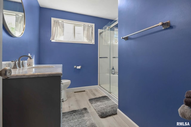 409 Arbor Dr, Carterville, IL 62918 - bathroom with wood finished floors, vanity, toilet, and a stall shower