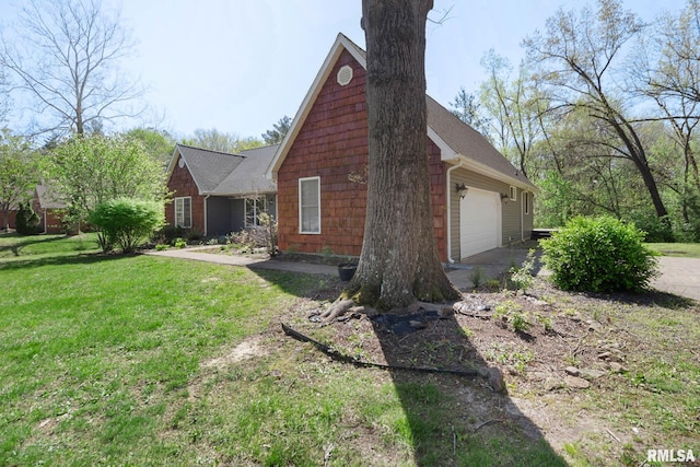 409 Arbor Dr, Carterville, IL 62918 - view of side of property featuring a lawn, aphalt driveway, and a garage