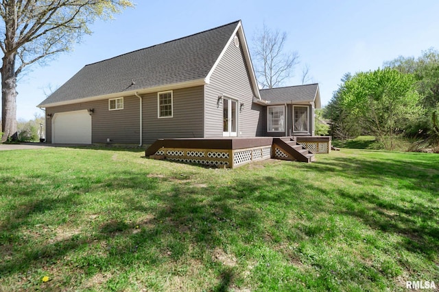409 Arbor Dr, Carterville, IL 62918 - back of house featuring a lawn, an attached garage, driveway, and a wooden deck