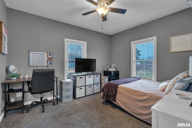 bedroom with a ceiling fan, multiple windows, and carpet
