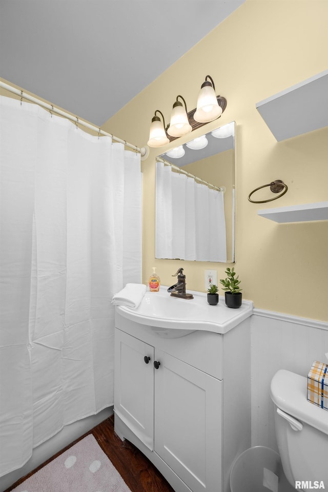 2302 Western Ave, Davenport, IA 52803 - full bathroom with vanity, wainscoting, wood finished floors, and a shower with shower curtain