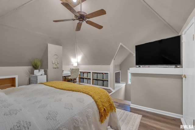 bedroom featuring lofted ceiling, baseboards, a ceiling fan, and wood finished floors