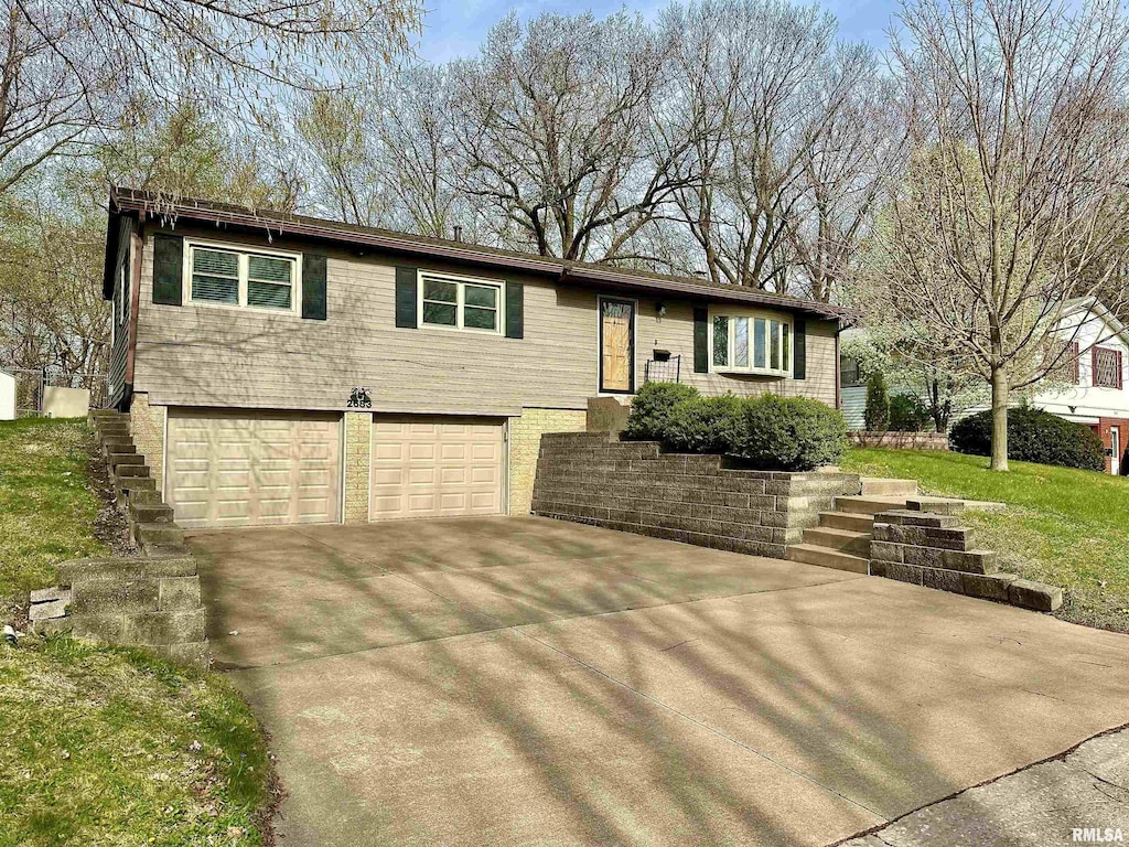 view of front of house with an attached garage and concrete driveway
