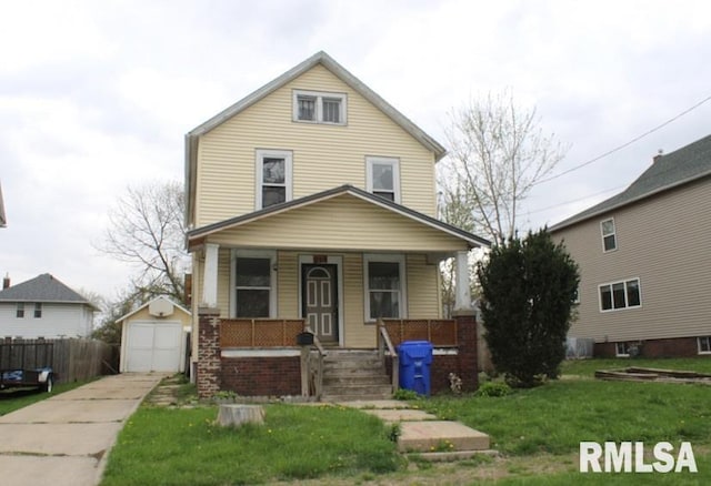 view of front of property with concrete driveway, an outbuilding, a porch, a front yard, and a garage