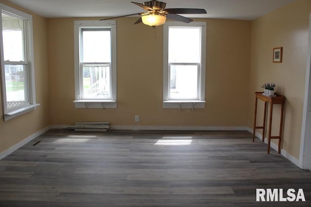unfurnished room featuring ceiling fan, baseboards, and wood finished floors